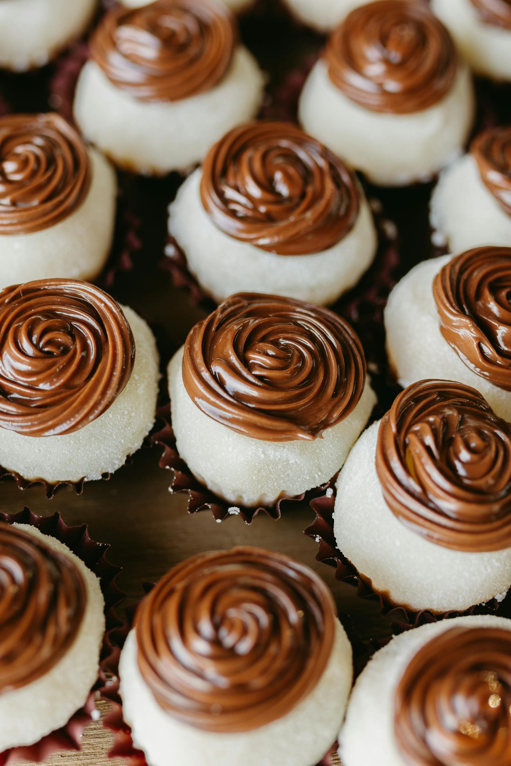 A delightful array of homemade pastries with rich chocolate spirals on top.
