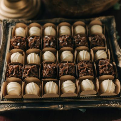 Beautiful gourmet chocolate confections on a vintage tray, perfect for dessert presentations.