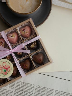 Indulge in a gourmet chocolate box paired with a latte, perfect for gifting or special occasions.