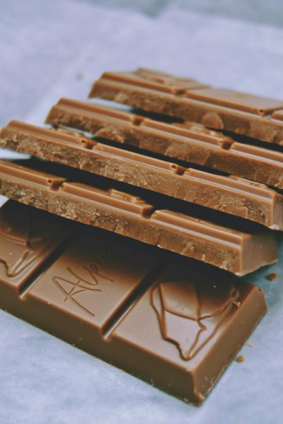 Stack of delicious milk chocolate bars with detailed cocoa texture, perfect for sweet cravings.