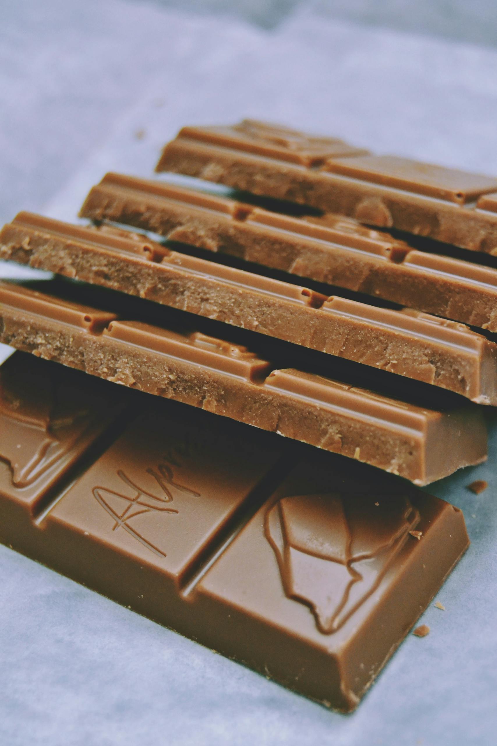 Stack of delicious milk chocolate bars with detailed cocoa texture, perfect for sweet cravings.